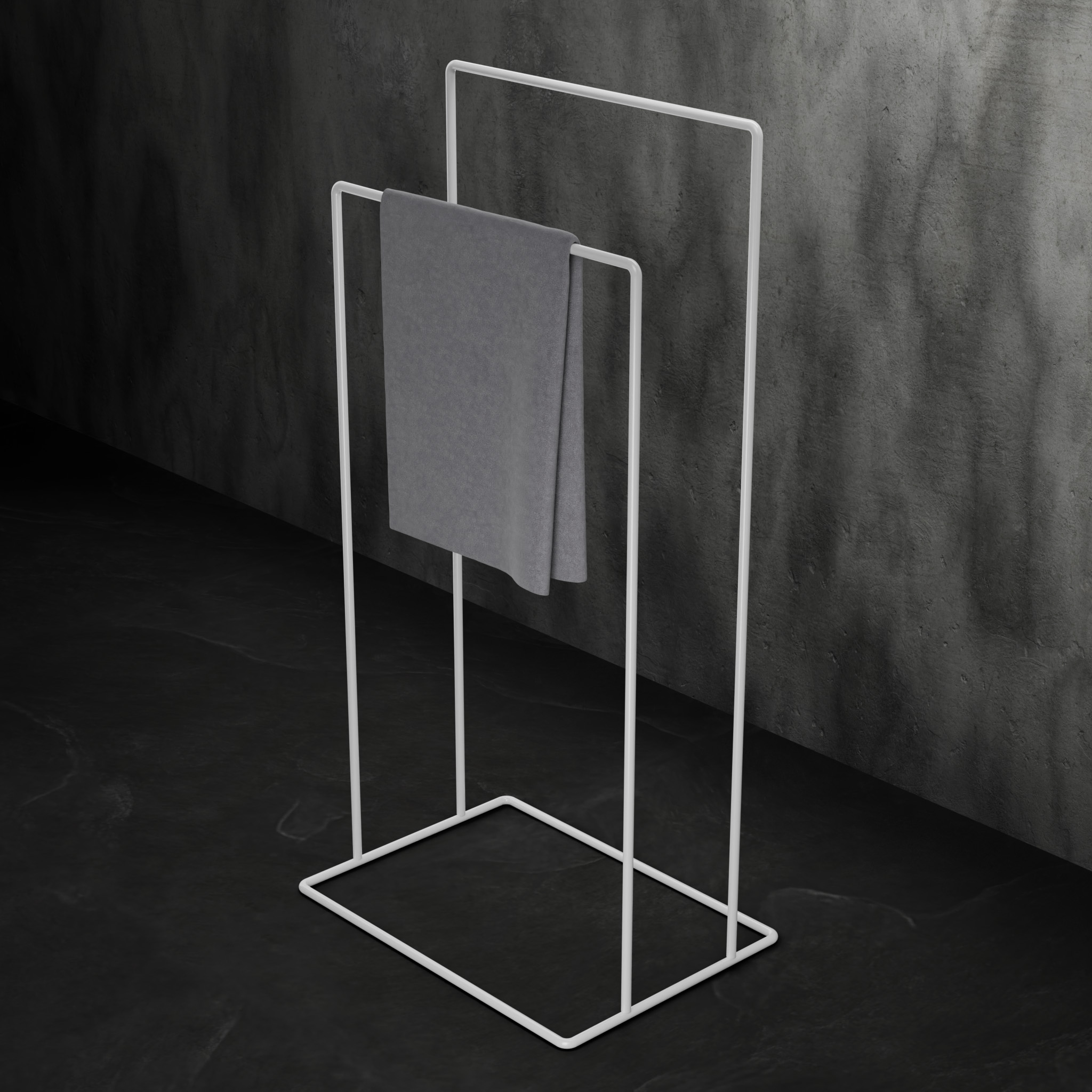 biały, minimalistyczny stojak łazienkowy na ręczniki AVRO ustawiony na ciemnej, betonowej podłodze przy ścianie z surowego betonu.